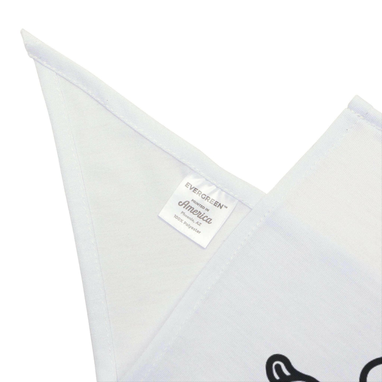 Close-up of a white Evergreen America fabric product label on a neatly stitched cloth with partial black design.